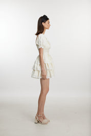 White ruffled mini dress with ruff sleeves