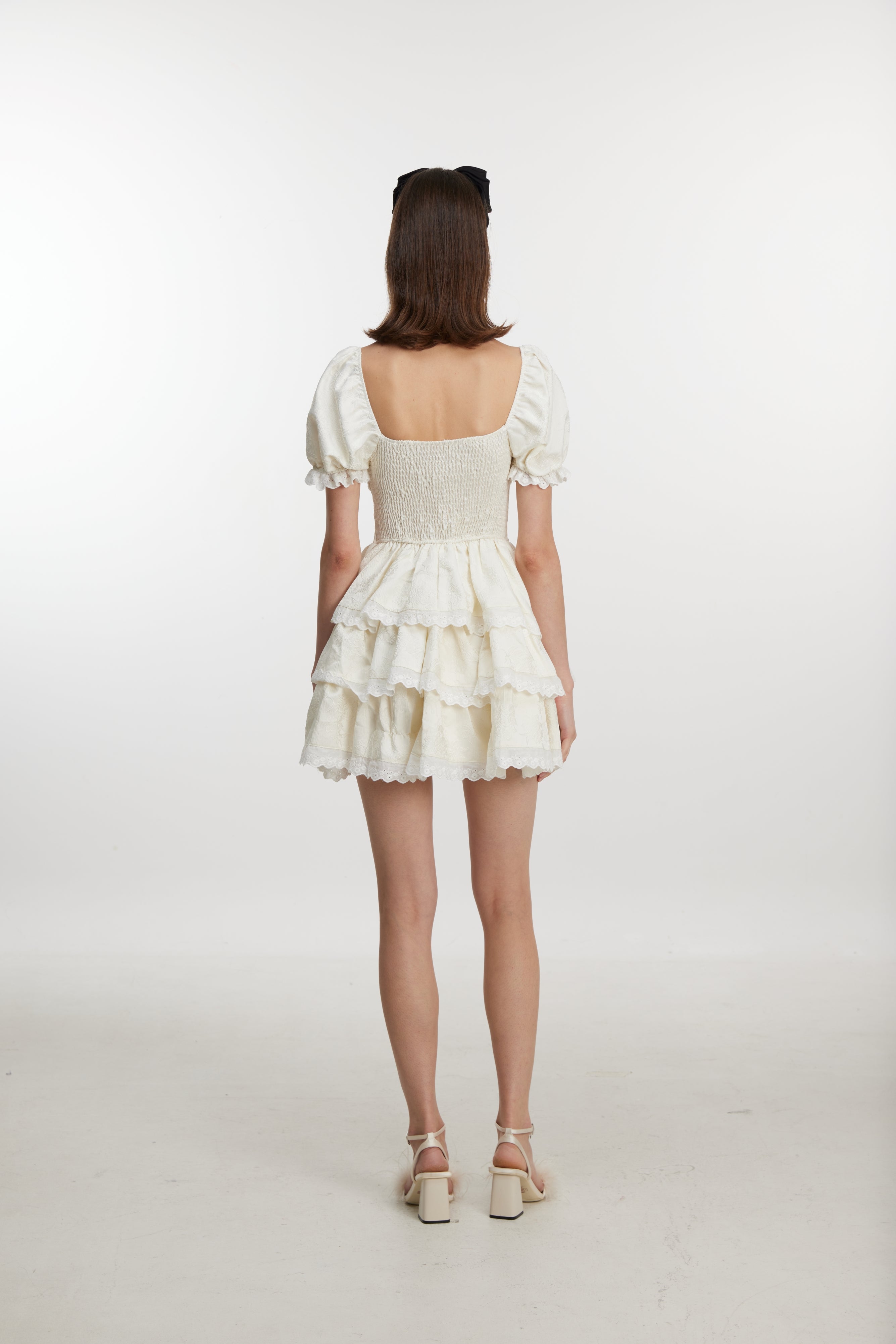 White ruffled mini dress with ruff sleeves