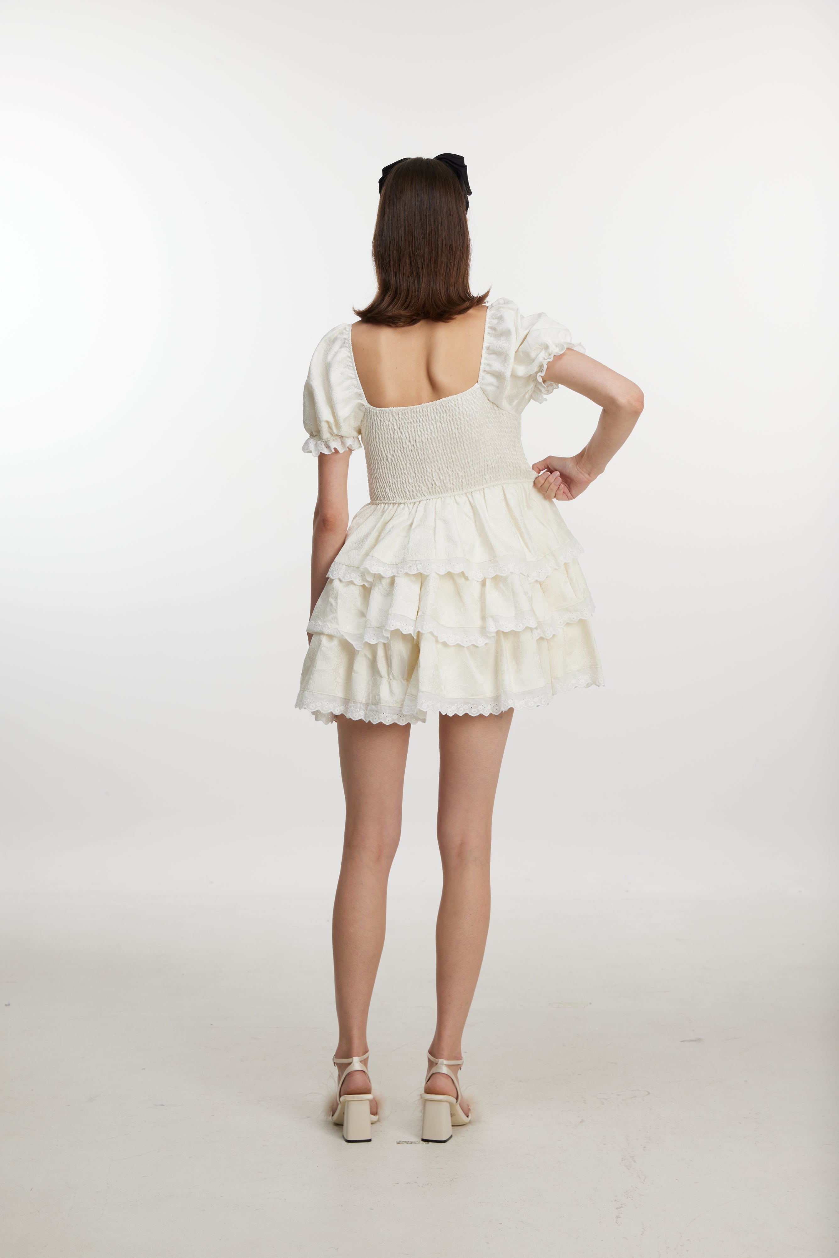 White ruffled mini dress with ruff sleeves