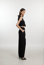 Stylish black ensemble with cropped vest and wide-leg pants