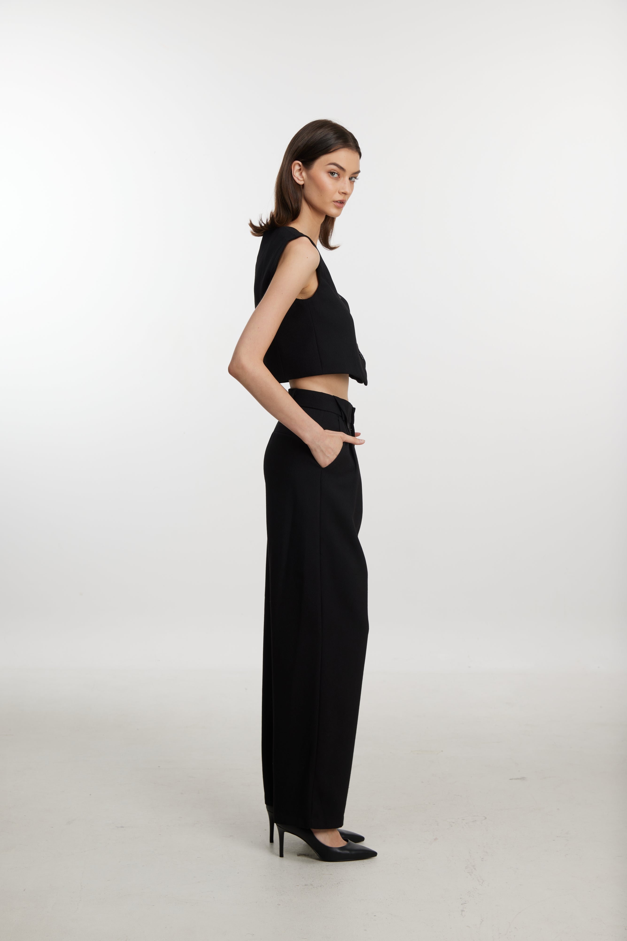 Stylish black ensemble with cropped vest and wide-leg pants
