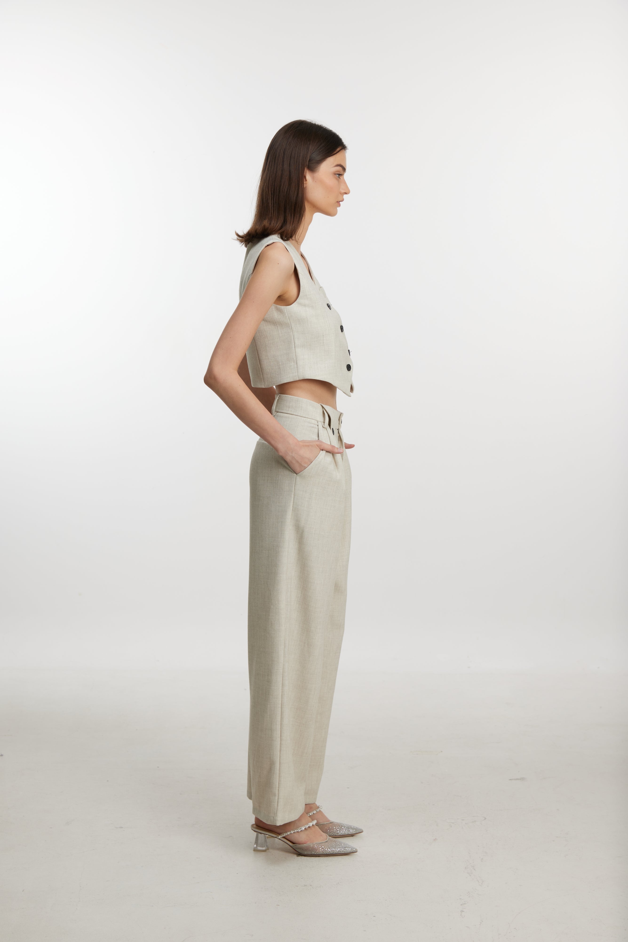 Stylish white ensemble with cropped vest and wide-leg pants