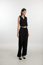 Stylish black ensemble with cropped vest and wide-leg pants