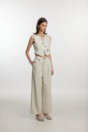 Stylish white ensemble with cropped vest and wide-leg pants