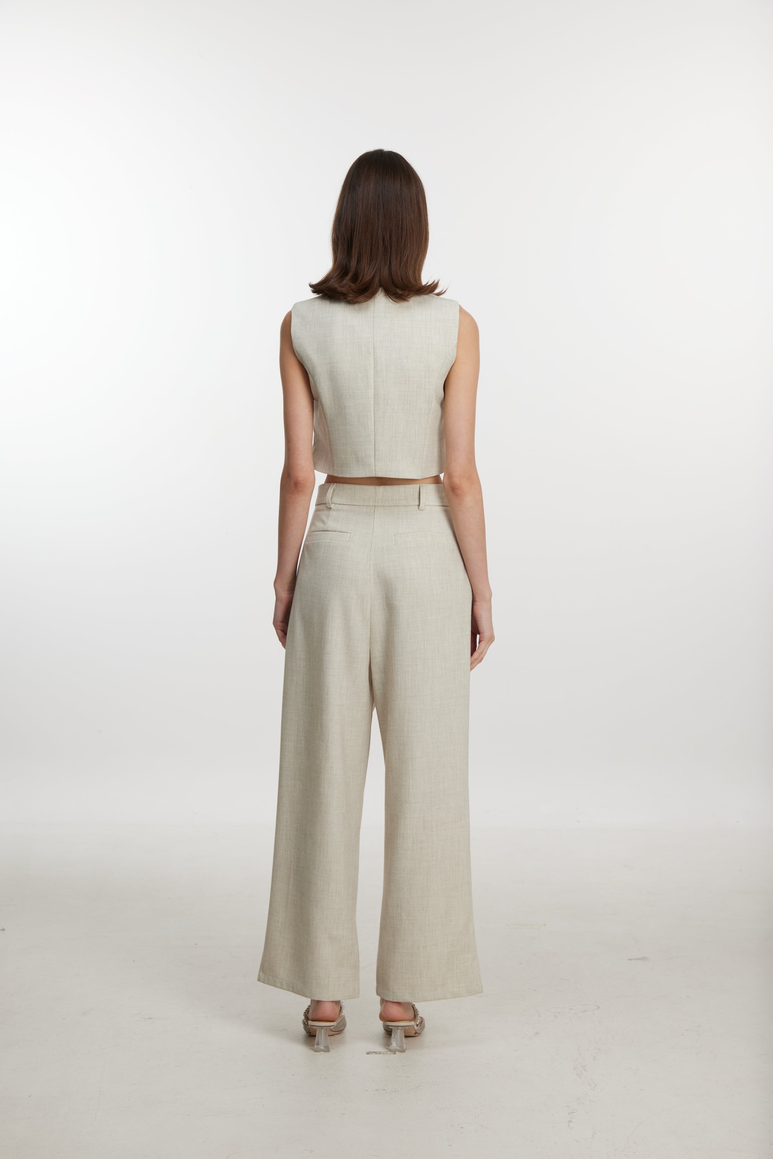 Stylish white ensemble with cropped vest and wide-leg pants
