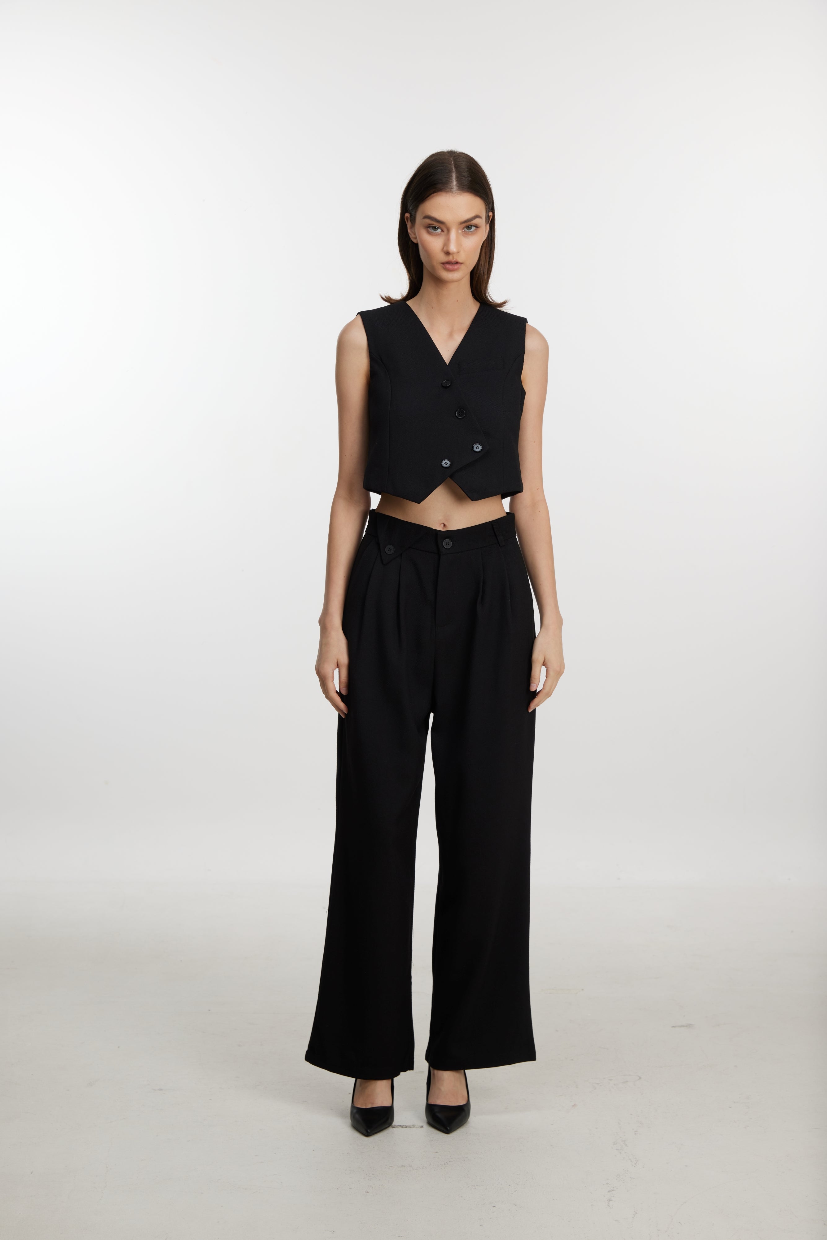 Stylish black ensemble with cropped vest and wide-leg pants