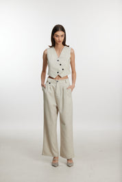 Stylish white ensemble with cropped vest and wide-leg pants