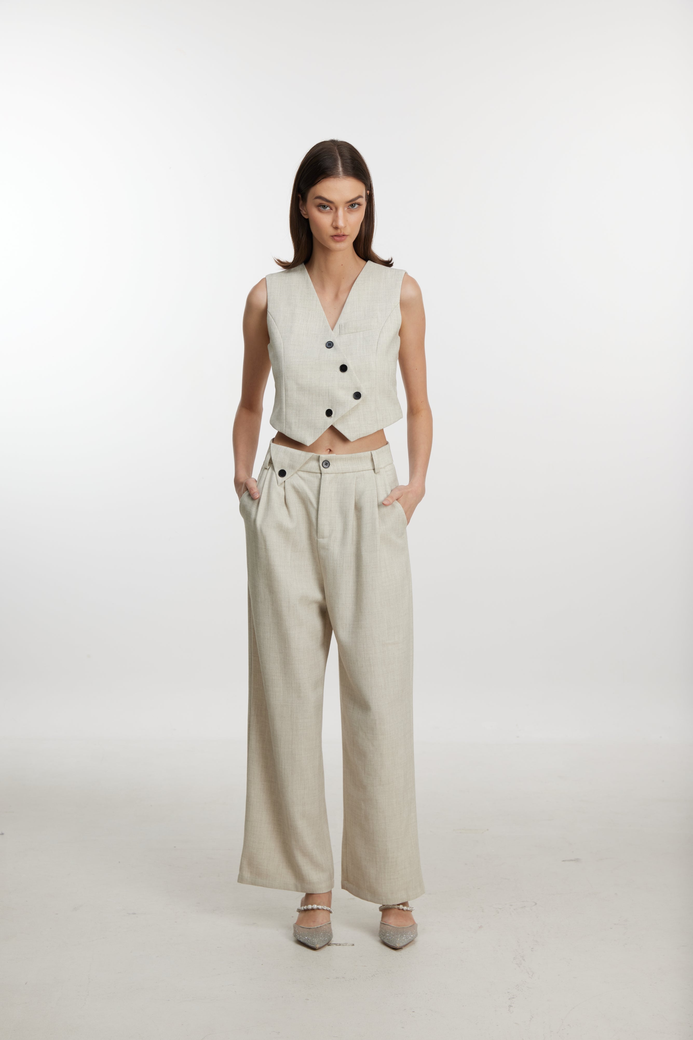 Stylish white ensemble with cropped vest and wide-leg pants